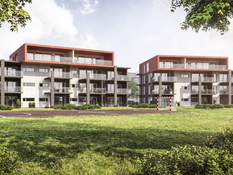 To leilighetsbygg i et gressområde.