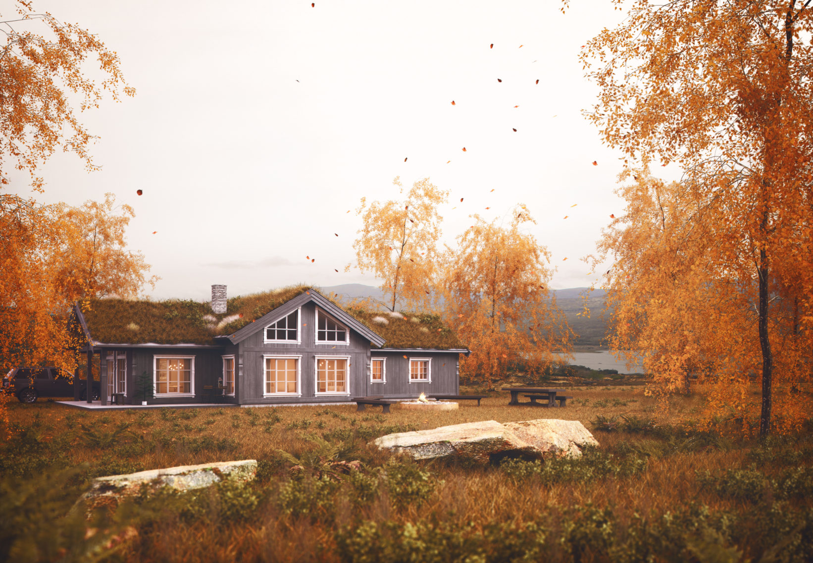 Et Norge hus i en åker med høstløv.