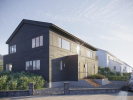 et svart hus med en bil parkert foran.