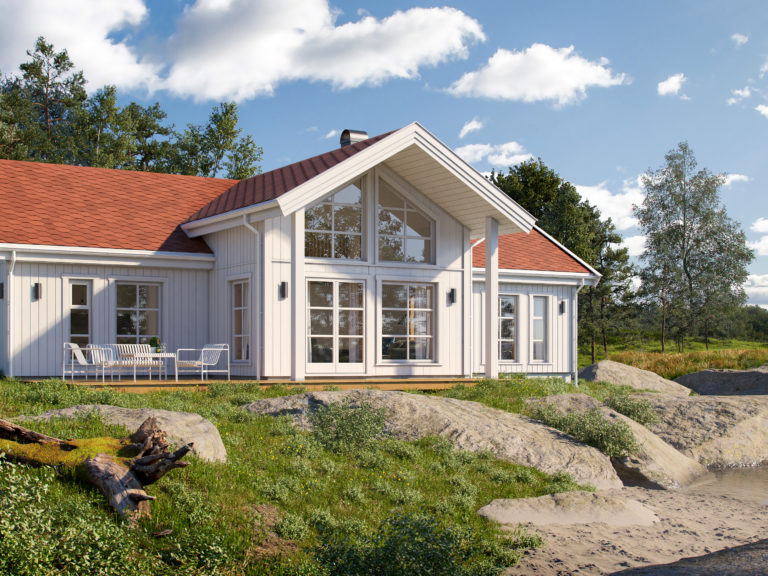 et hvitt hus med rødt tak ved siden av en vannmasse.
