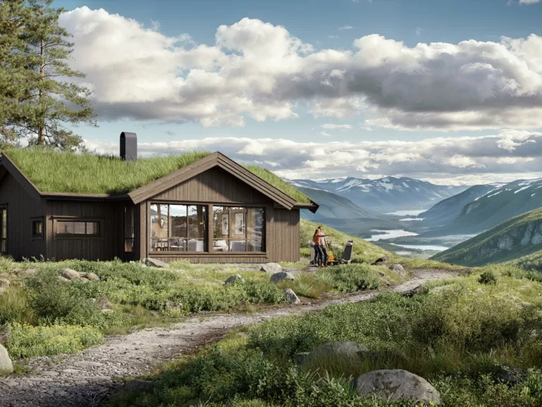 En trehytte med grønt tak ligger i et frodig fjellandskap. To personer er utenfor, den ene skyver en trillebår langs en steinete sti. Snødekte topper og en elv er synlige i bakgrunnen.